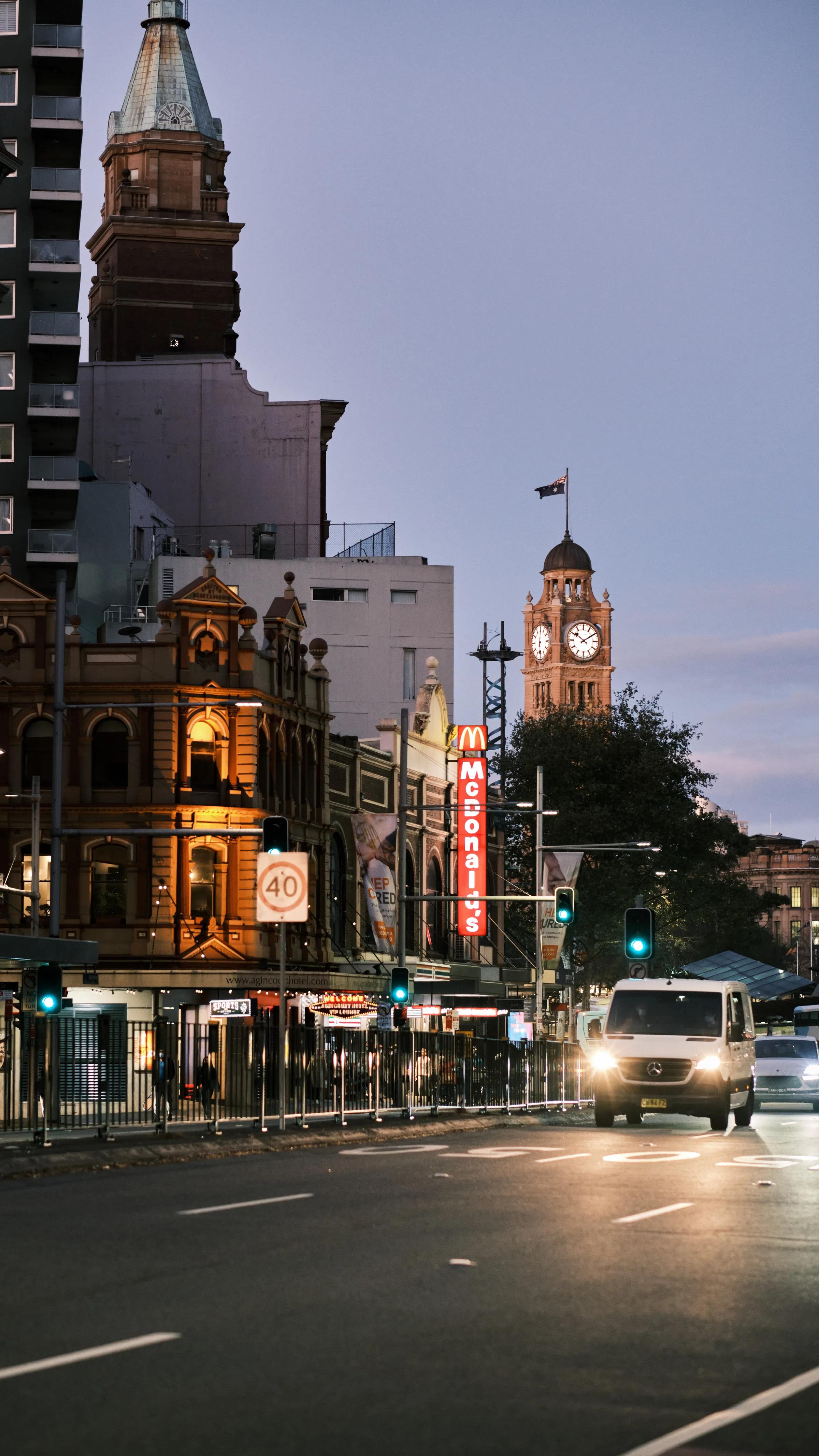 Clock Tower Over Evening Traffic